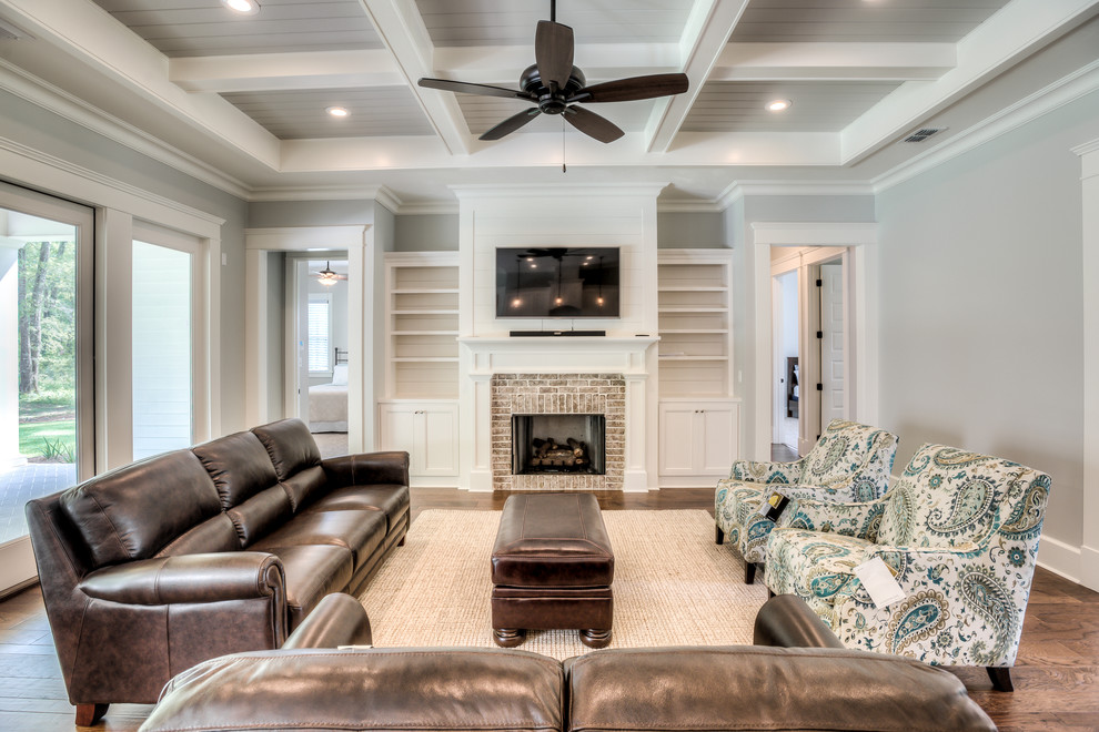 Inspiration for a mid-sized craftsman open concept family room remodel in Atlanta with gray walls, a standard fireplace, a brick fireplace and a wall-mounted tv