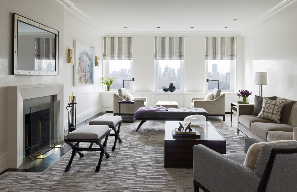 Immagine di un soggiorno design con pareti bianche, camino classico e TV a parete