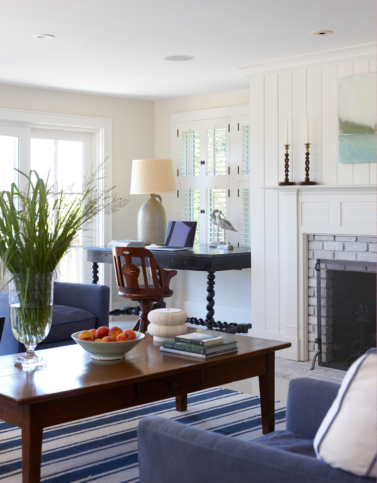 Example of a large beach style open concept porcelain tile and white floor family room design in Boston with beige walls, a standard fireplace, a brick fireplace and no tv