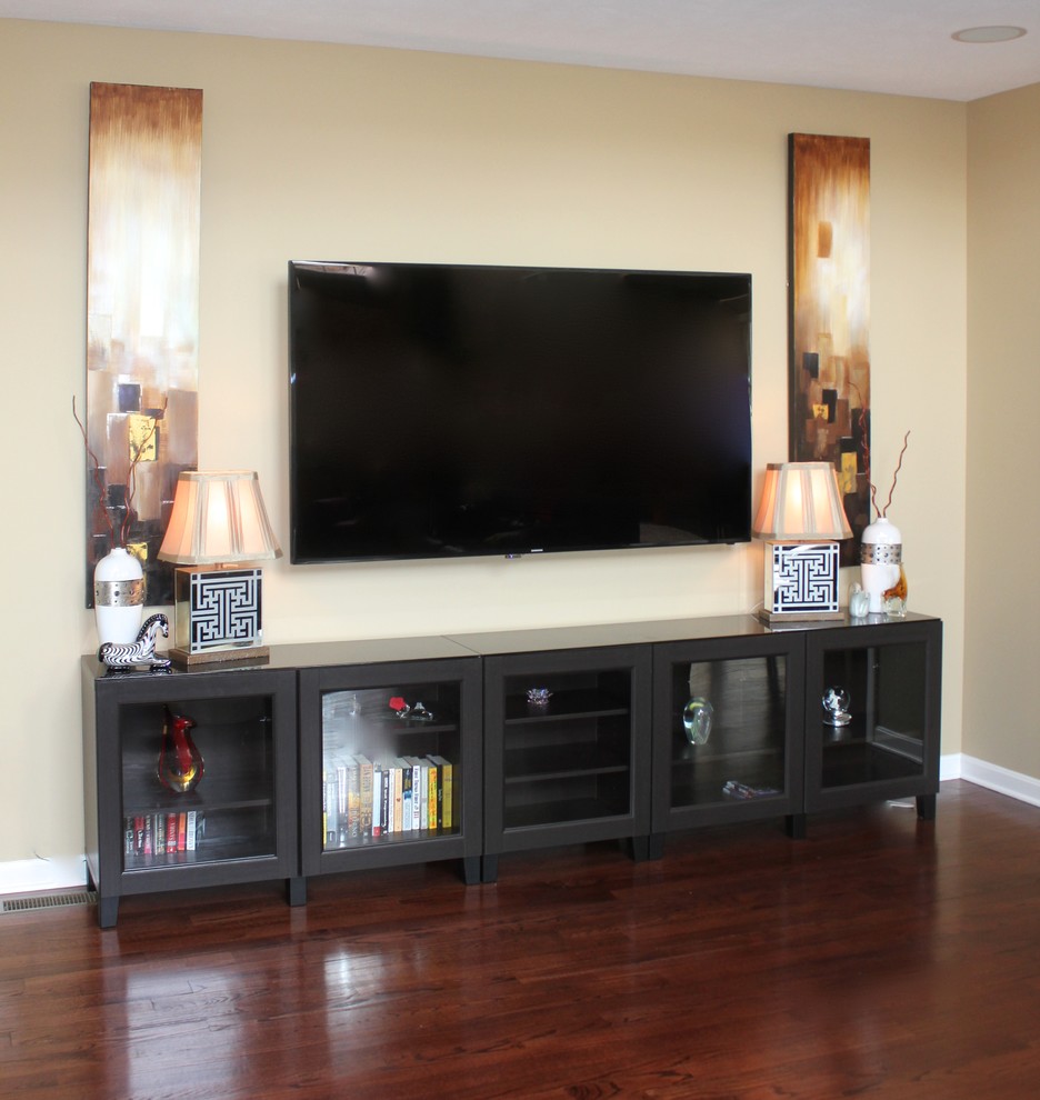 Photo of a medium sized modern open plan games room in Nashville with beige walls, medium hardwood flooring, a standard fireplace and a wall mounted tv.