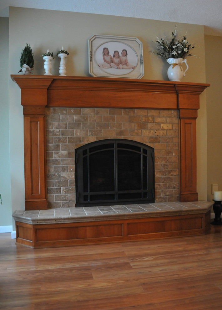 Family room - traditional medium tone wood floor family room idea in New York with a standard fireplace and a tile fireplace