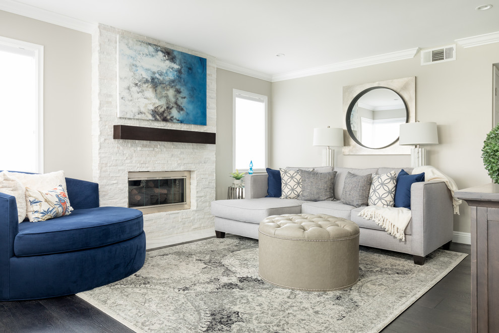 Inspiration for a medium sized contemporary open plan games room in Orange County with dark hardwood flooring, a standard fireplace, a stone fireplace surround, a wall mounted tv and brown floors.