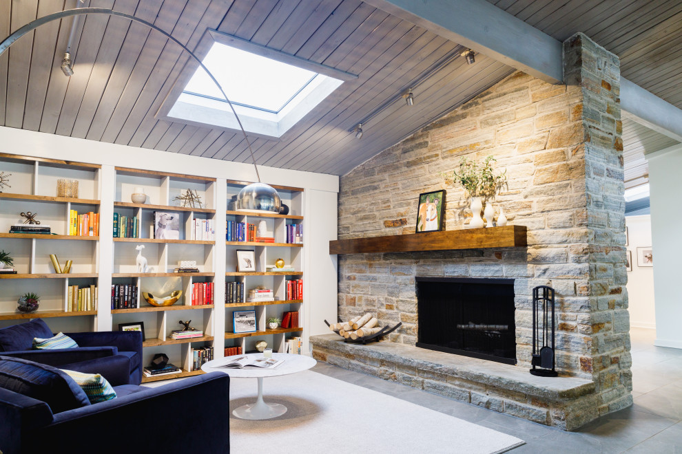 Inspiration for a mid-sized transitional open concept slate floor and gray floor family room remodel in Baltimore with white walls, a standard fireplace, a stone fireplace and no tv