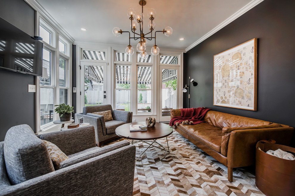 Example of a mid-sized transitional enclosed multicolored floor family room design in Columbus with black walls, a wall-mounted tv and no fireplace