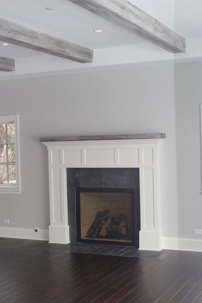Inspiration for a transitional family room remodel in Chicago with a wood fireplace surround