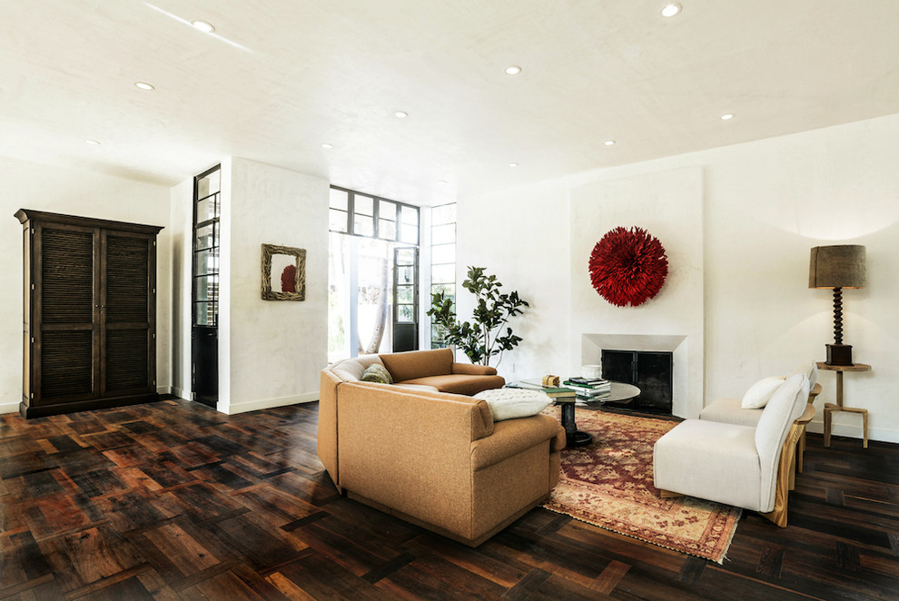 Inspiration for a large open concept family room library remodel in Los Angeles with white walls, a standard fireplace, a plaster fireplace and no tv