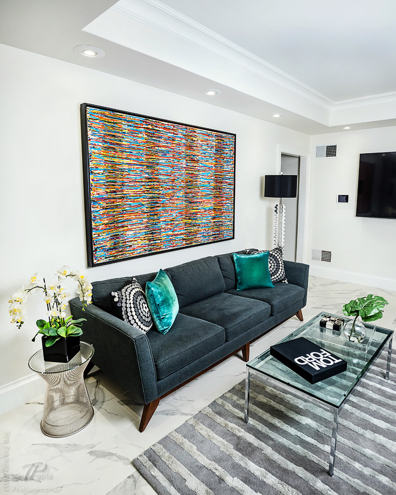 Photo of a small modern open plan games room in Baltimore with white walls, marble flooring, a wall mounted tv and white floors.