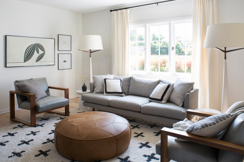 Immagine di un soggiorno minimalista di medie dimensioni e chiuso con pareti bianche, pavimento in legno massello medio e pavimento marrone