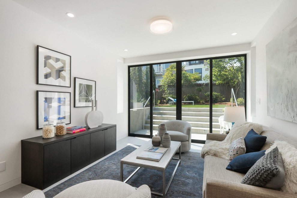 Foto di un soggiorno minimal di medie dimensioni e aperto con pareti bianche, pavimento in gres porcellanato e pavimento grigio