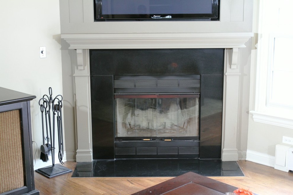 Example of a mid-sized classic enclosed medium tone wood floor family room design in Chicago with gray walls, a corner fireplace, a stone fireplace and a media wall