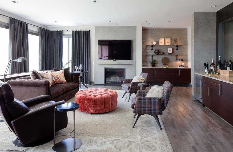 Inspiration for a contemporary games room in Seattle with a home bar, white walls, dark hardwood flooring, a standard fireplace, a wall mounted tv and brown floors.