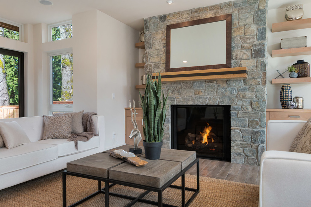 Large contemporary open plan games room in Seattle with white walls, light hardwood flooring, a standard fireplace and a stone fireplace surround.