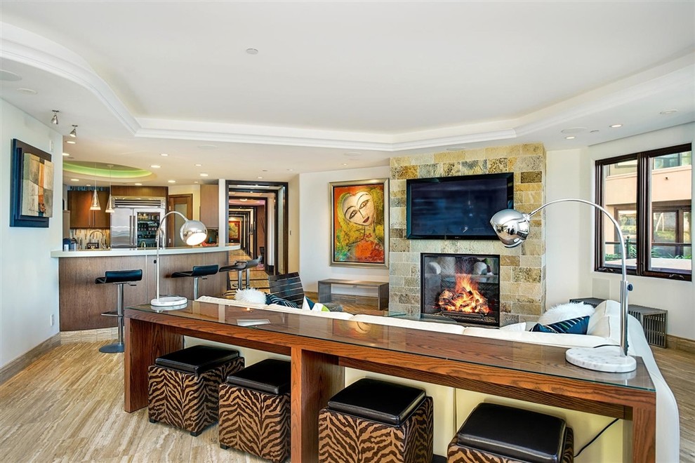 Photo of a contemporary open plan games room in San Diego with white walls, a stone fireplace surround, a wall mounted tv, beige floors and a corner fireplace.