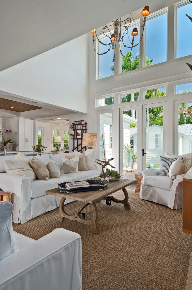 Family room - mid-sized coastal open concept dark wood floor family room idea in Miami with white walls and a wall-mounted tv
