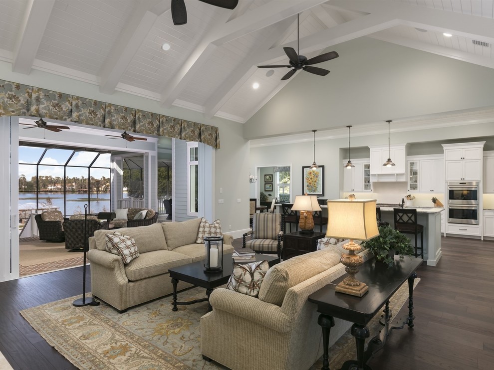 Example of a large beach style open concept dark wood floor and brown floor family room design in Orlando with gray walls, a standard fireplace and a tile fireplace