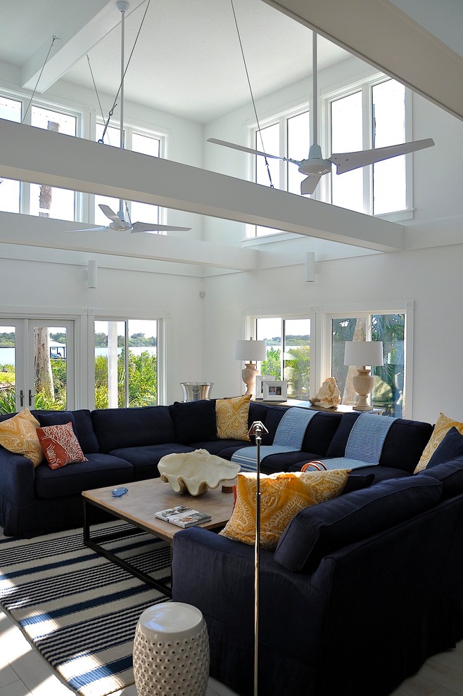 Inspiration for a large coastal open concept family room remodel in Orlando with white walls