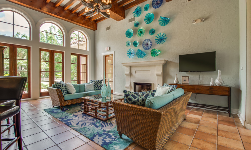 Inspiration for a medium sized coastal enclosed games room in Houston with blue walls, terracotta flooring, a standard fireplace, a wall mounted tv and orange floors.