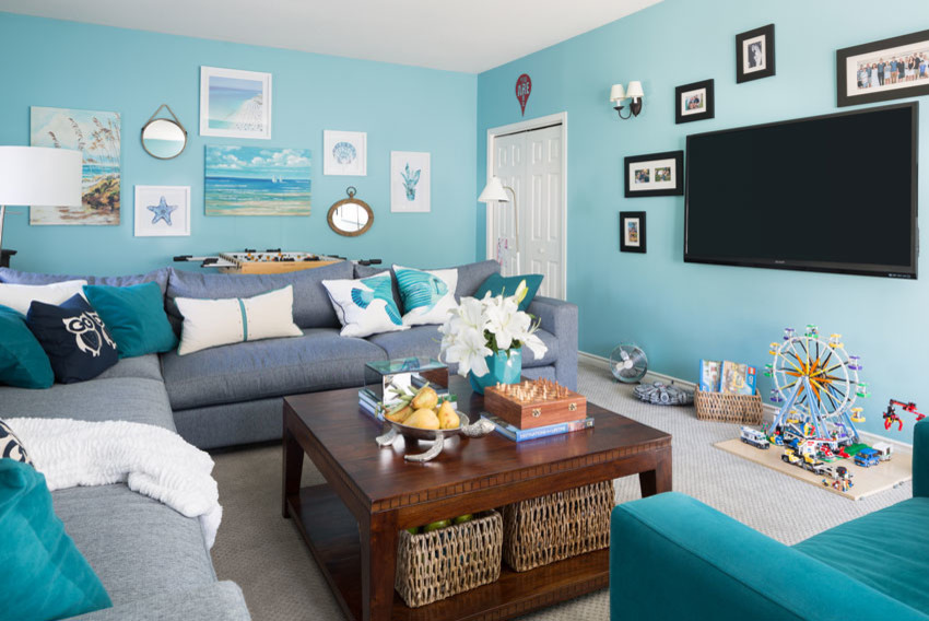 Mid-sized beach style enclosed carpeted and gray floor family room photo in Vancouver with blue walls and a wall-mounted tv