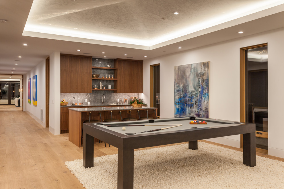 Inspiration for a large contemporary mezzanine games room in Orange County with white walls, light hardwood flooring, a game room and beige floors.
