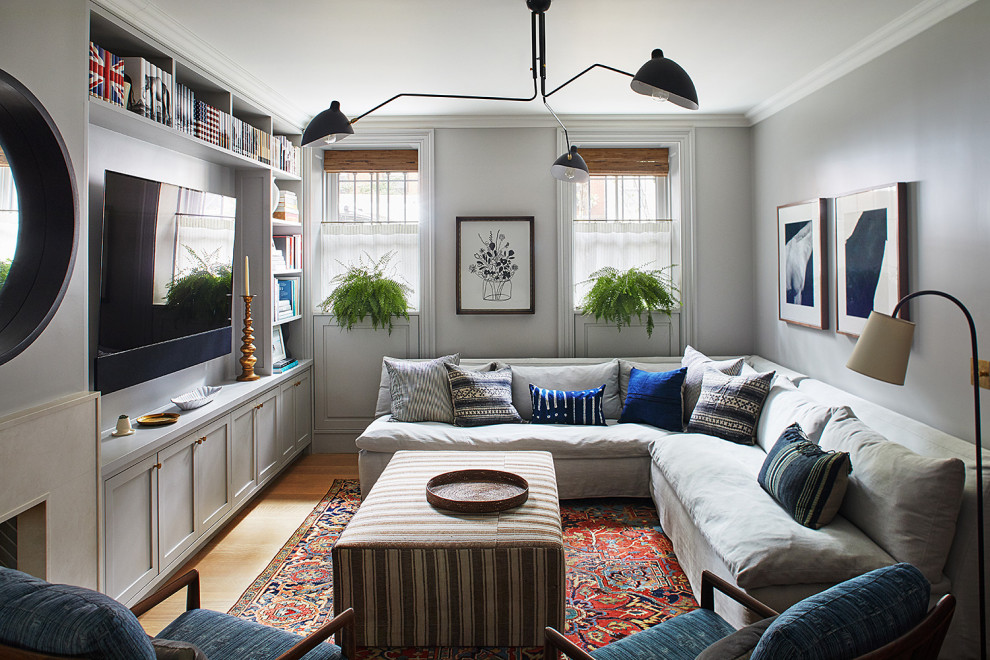 Inspiration for a transitional family room remodel in New York with a wall-mounted tv