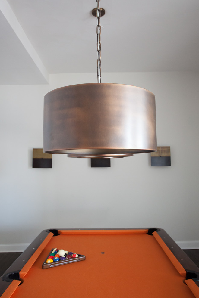 Large urban loft-style dark wood floor game room photo in New York with white walls and no tv