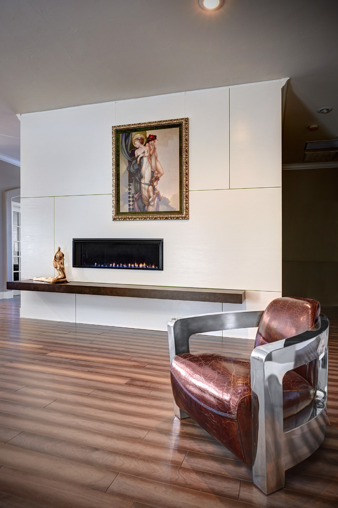 Mid-sized trendy open concept medium tone wood floor family room photo in Sacramento with white walls, a standard fireplace and a tile fireplace