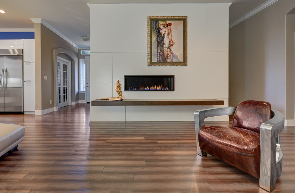 This is an example of a medium sized contemporary open plan games room in Sacramento with white walls, medium hardwood flooring, a standard fireplace and a tiled fireplace surround.