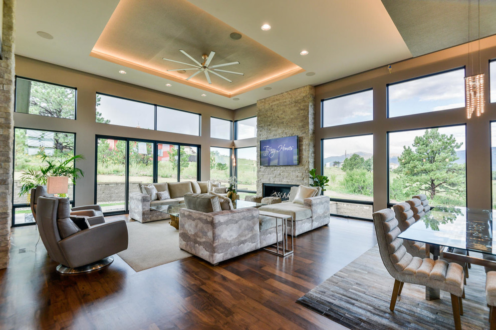 Inspiration for a mid-sized contemporary open concept dark wood floor and brown floor family room remodel in Denver with beige walls, a ribbon fireplace, a stone fireplace and a wall-mounted tv