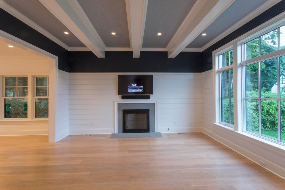 Family room - large farmhouse open concept light wood floor and beige floor family room idea in New York with white walls, a standard fireplace, a concrete fireplace and a wall-mounted tv