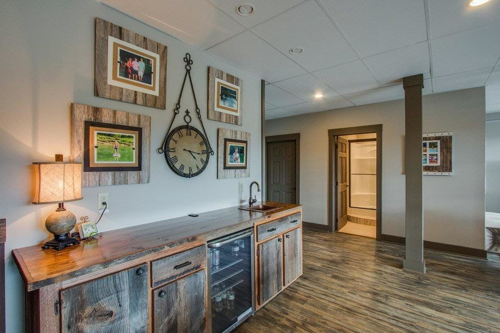 Example of a large classic open concept medium tone wood floor and brown floor game room design in Nashville with beige walls