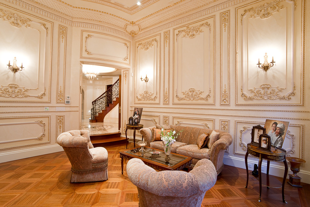 Imagen de sala de estar cerrada clásica con paredes beige y suelo de madera en tonos medios