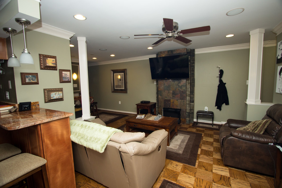 Example of a mid-sized classic open concept medium tone wood floor family room design in DC Metro with green walls, a two-sided fireplace, a stone fireplace and a wall-mounted tv