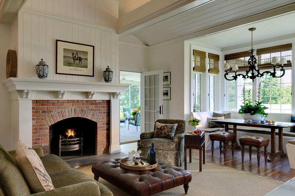 Elegant open concept family room photo in New York with white walls, a standard fireplace and a brick fireplace