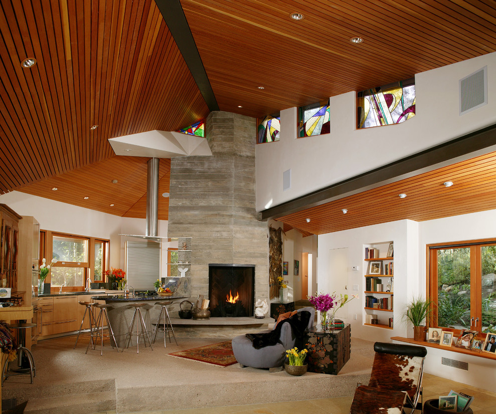 Ejemplo de sala de estar contemporánea con marco de chimenea de hormigón