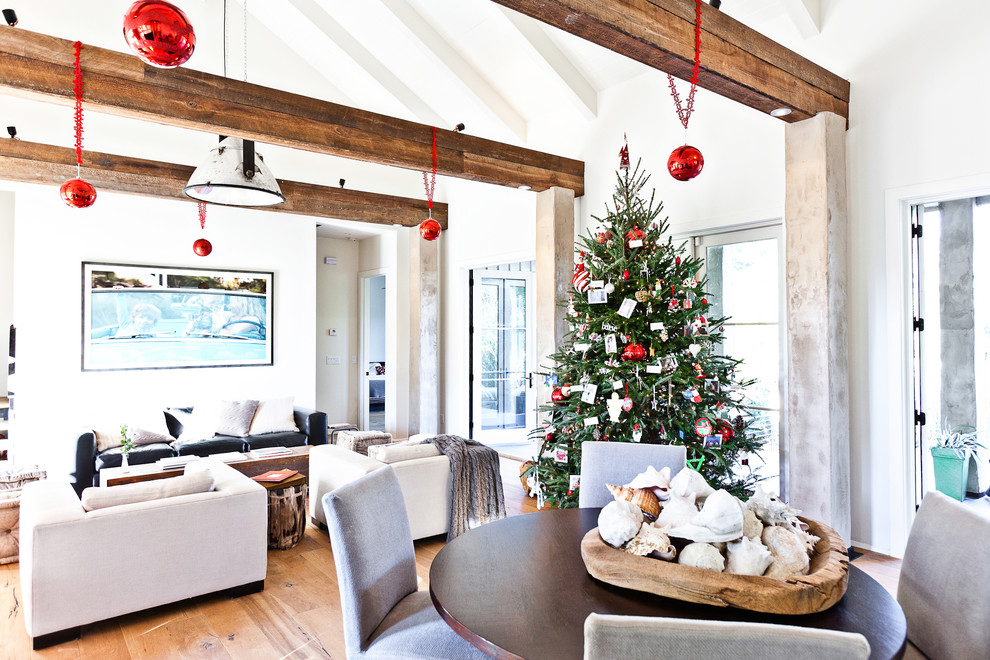 Trendy open concept medium tone wood floor family room photo in Charleston with white walls