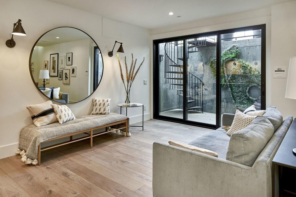 Inspiration for a contemporary light wood floor and beige floor family room remodel in San Francisco with white walls