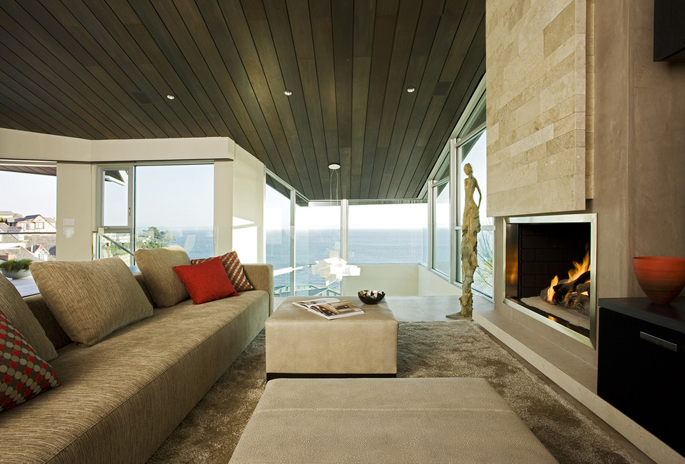 Foto de sala de estar abierta contemporánea con paredes beige y todas las chimeneas