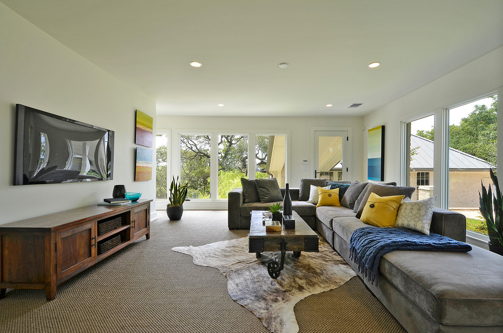 This is an example of a contemporary games room in Austin with beige walls, carpet, no fireplace and a wall mounted tv.