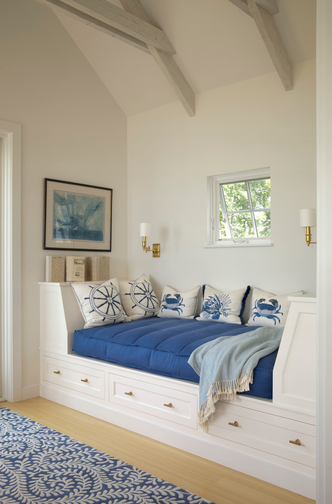 Example of a beach style light wood floor family room design in Portland Maine with white walls