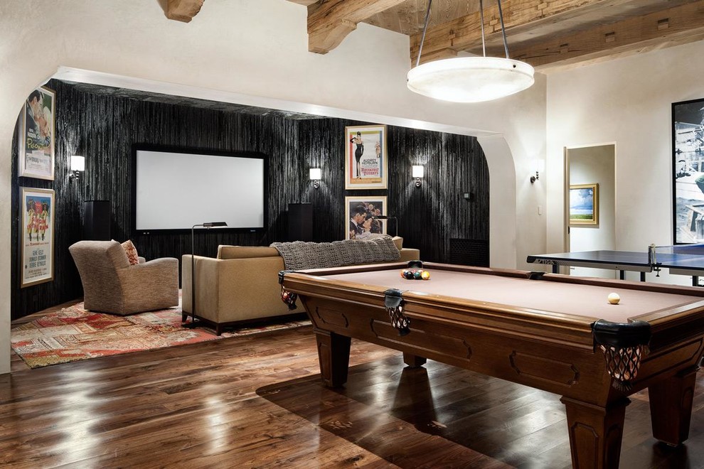 This is an example of a contemporary games room in Austin with brown floors.