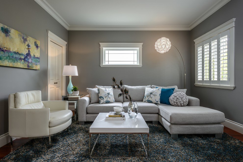 Inspiration for a mid-sized contemporary enclosed dark wood floor and brown floor family room remodel in Vancouver with gray walls, no fireplace and no tv