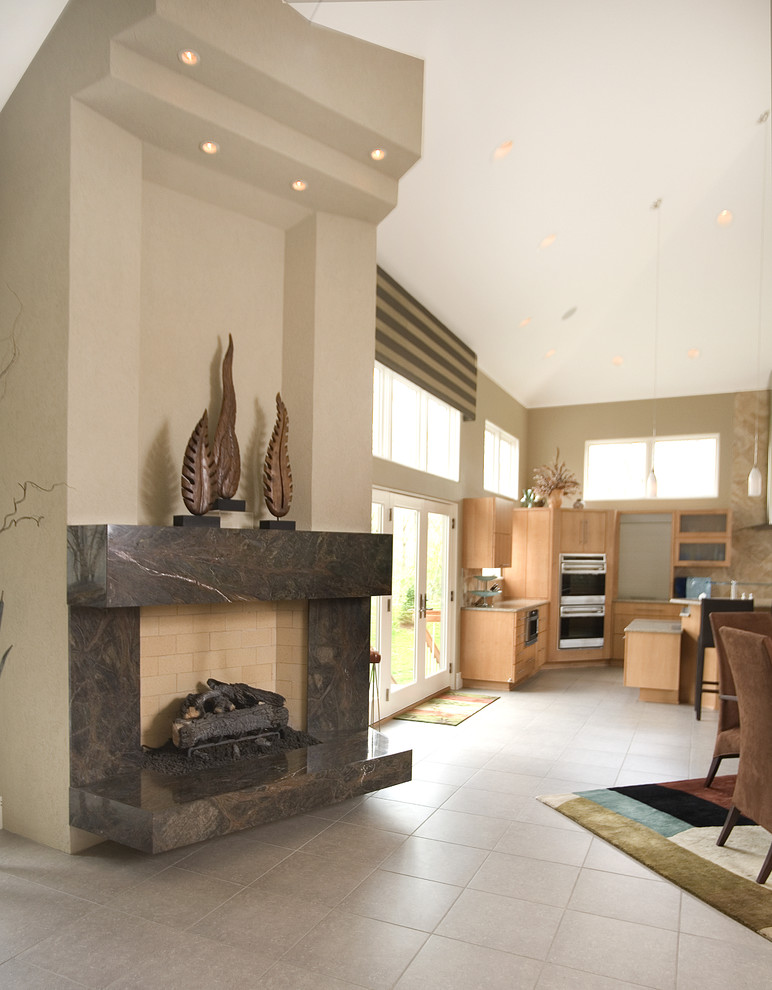 Photo of an expansive contemporary open plan games room in Other with a home bar, beige walls, ceramic flooring, a standard fireplace, a stone fireplace surround, a concealed tv and beige floors.
