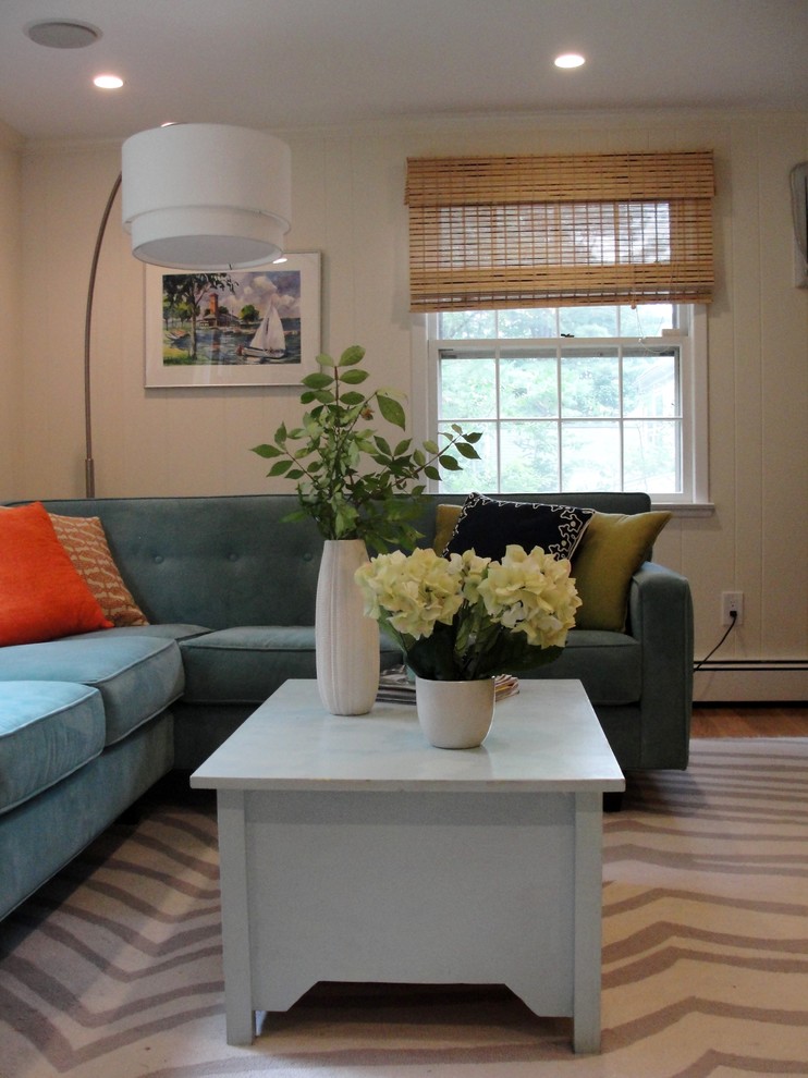 Example of a mid-sized eclectic enclosed light wood floor family room design in Boston with white walls and a wall-mounted tv