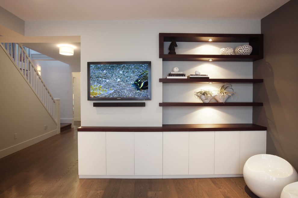 Inspiration for a contemporary dark wood floor family room remodel in Other with brown walls and a wall-mounted tv