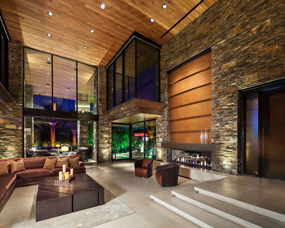 This is an example of a contemporary games room in Las Vegas with a two-sided fireplace.