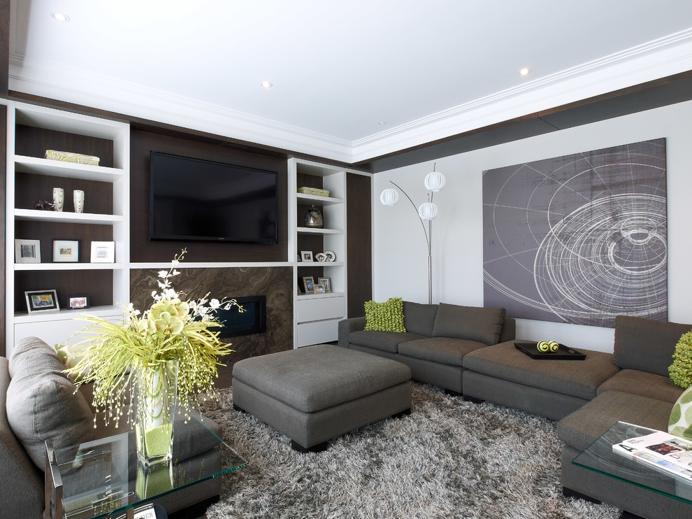 Large contemporary open concept family room in Toronto with grey walls, a ribbon fireplace, a stone fireplace surround, a wall-mounted tv, dark hardwood floors and brown floor.