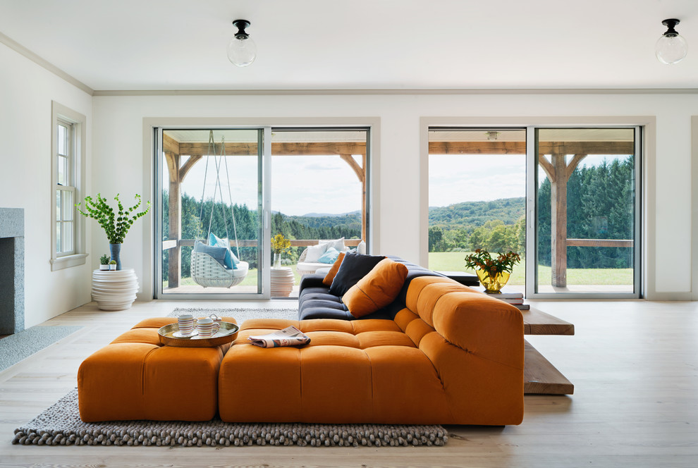 Family room - contemporary open concept light wood floor family room idea in New York with white walls