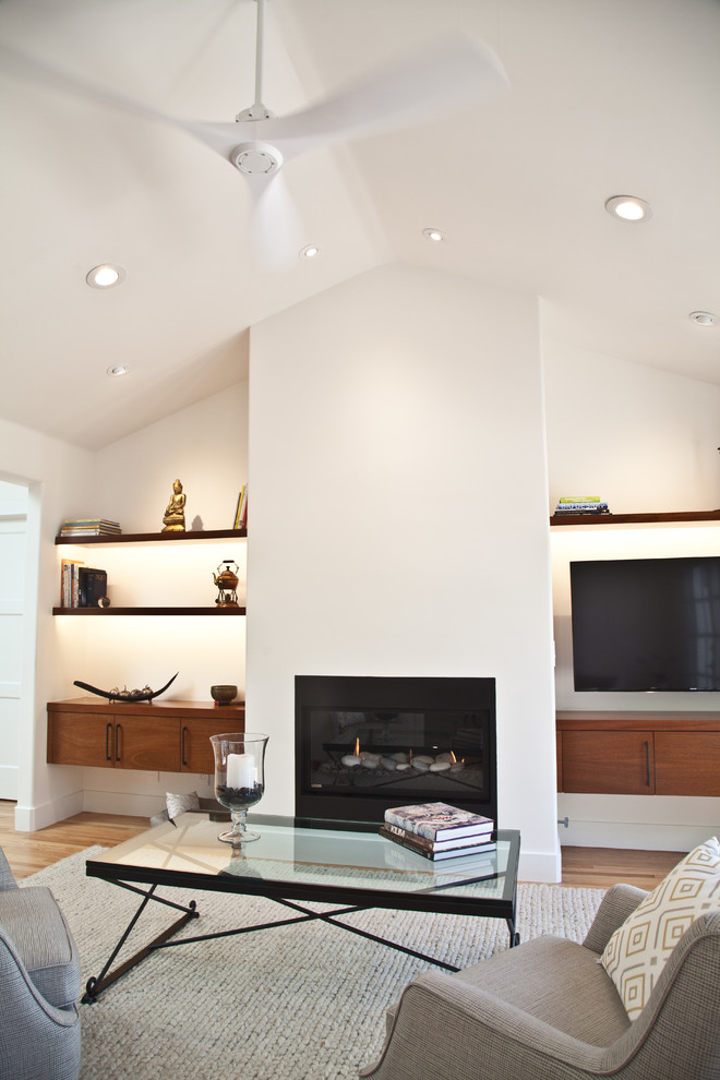 Photo of a medium sized contemporary open plan games room in San Francisco with white walls, light hardwood flooring, a ribbon fireplace, a plastered fireplace surround, a wall mounted tv and a music area.