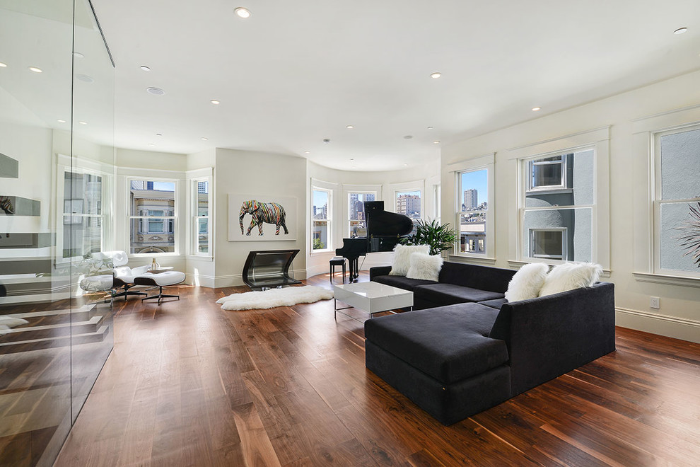 Example of a large trendy open concept dark wood floor and brown floor family room design in San Francisco with white walls, a standard fireplace, a metal fireplace and a music area