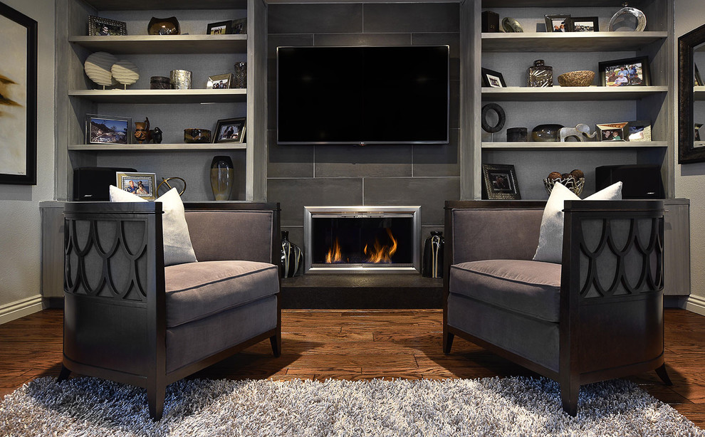 Mid-sized transitional enclosed dark wood floor and brown floor family room photo in Orange County with gray walls, a standard fireplace, a tile fireplace and a wall-mounted tv